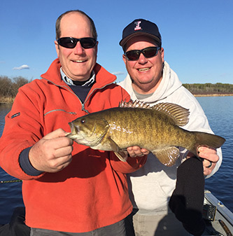 Father And Son With Big Smallmouth Bass Catch