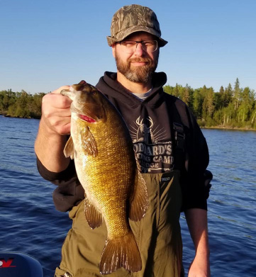 Guest Holding Big Smallmouth Bass Caught On Pakwash Lake Rev