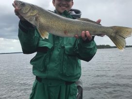 Happy Teen With Pike Walleye In Boat