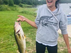 Lady Holding Up Big Bass Catch