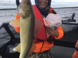 Mom With Baby Holding Up Her Fish Catch